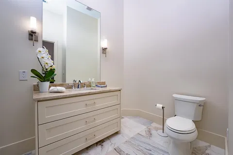 a bathroom with a sink vanity and toilet