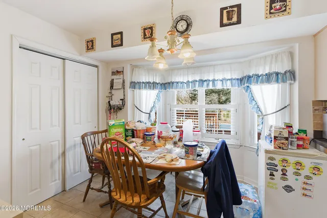 a view of a dining room with furniture window and outside view