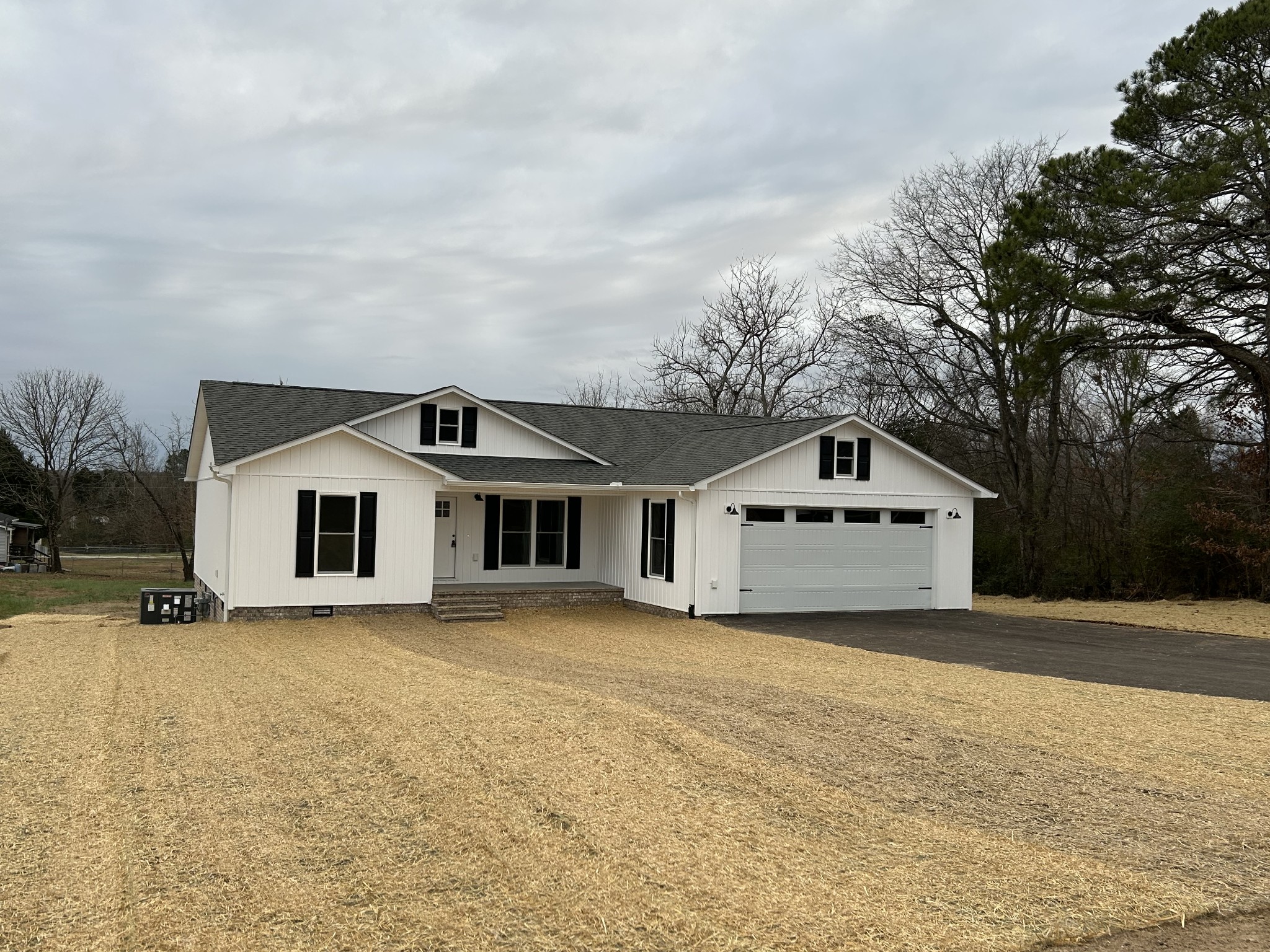 a big house with a big yard and large trees