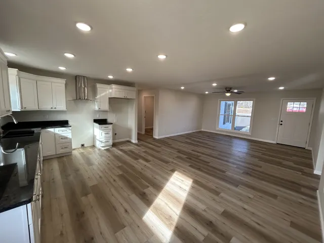 a view of kitchen with refrigerator and window