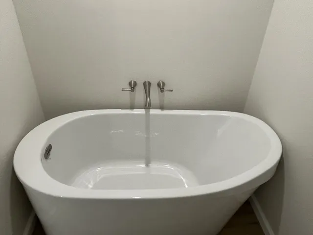 a white bath tub sitting in a bathroom