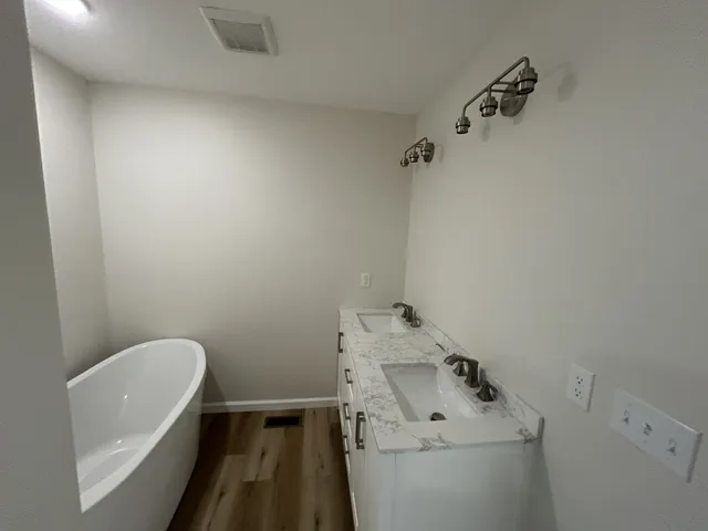a bathroom with a shower and a sink