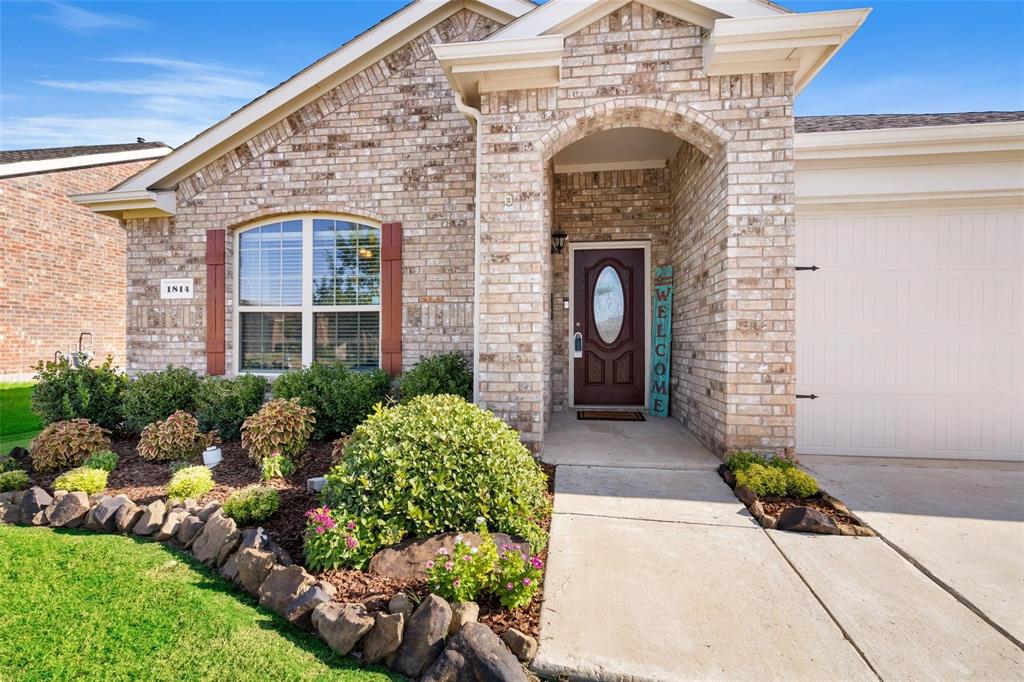1814 Prairie View Drive Princeton, TX 75407 - Photo 1 of 1 Doorway to property with a garage, brick siding, and concrete driveway