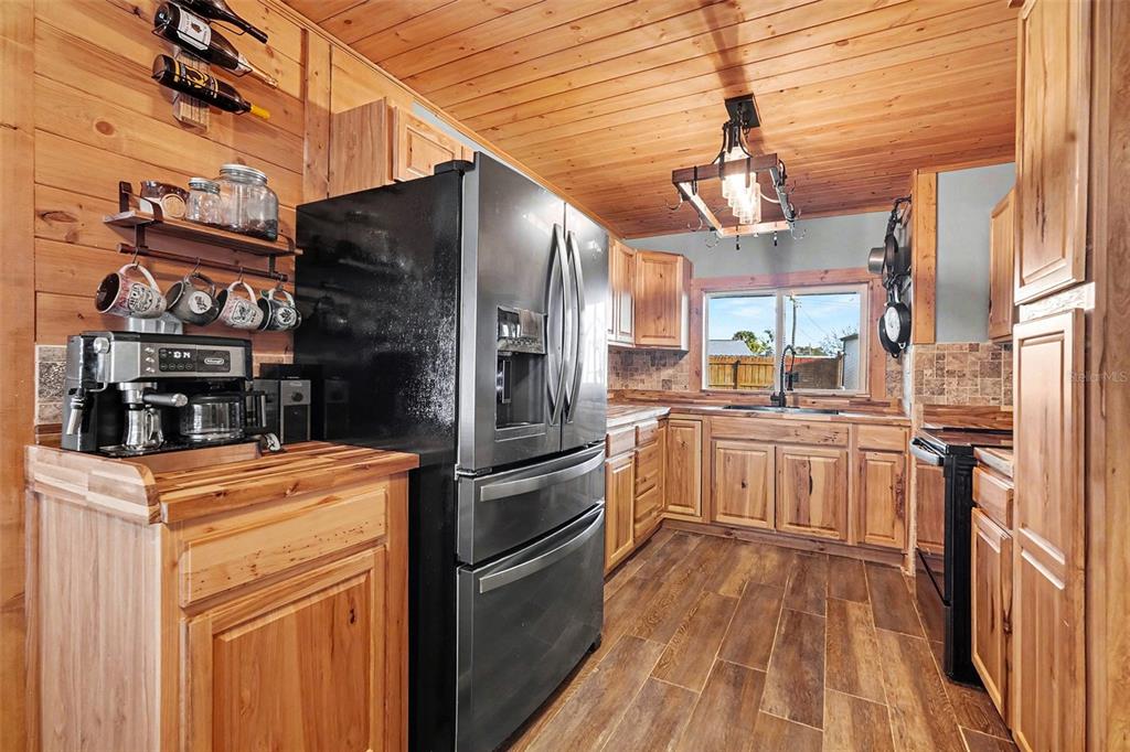557 Flame Tree Drive Apollo Beach, FL 33572 - Photo 11 of 31 a kitchen with a refrigerator and countertop