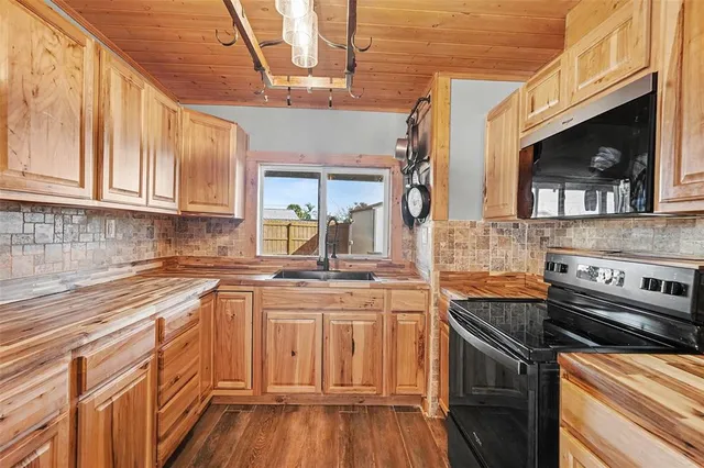 a kitchen with stainless steel appliances granite countertop a sink and cabinets
