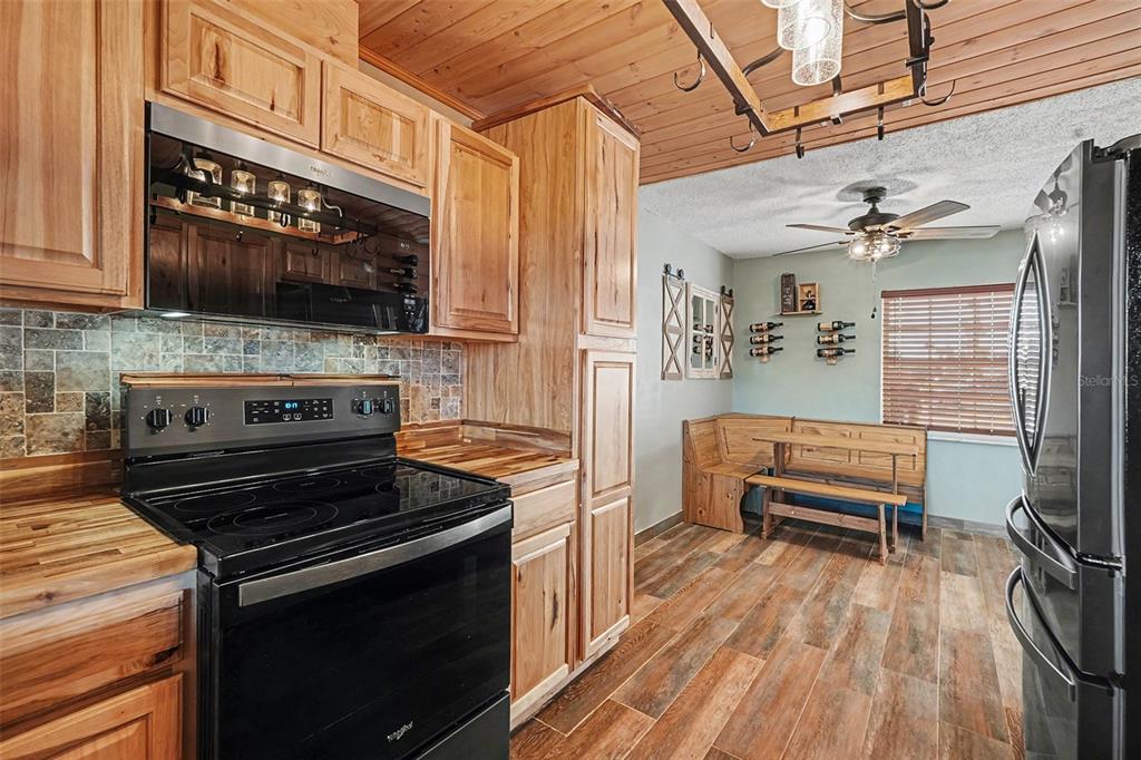 557 Flame Tree Drive Apollo Beach, FL 33572 - Photo 13 of 31 a kitchen with a stove and a microwave