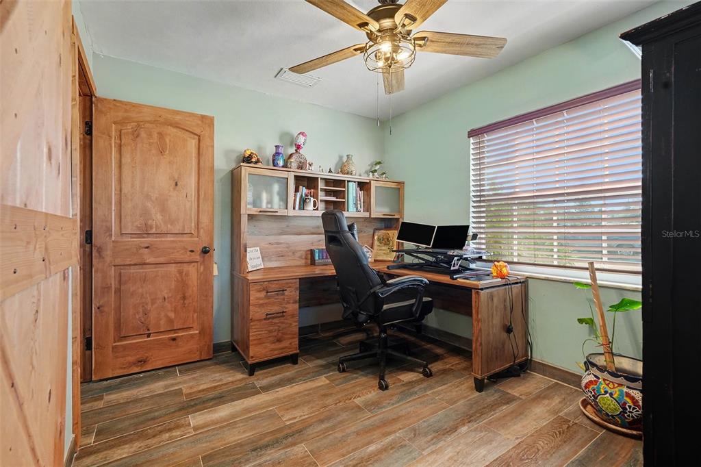 557 Flame Tree Drive Apollo Beach, FL 33572 - Photo 20 of 31 a view of a workspace with furniture and a window