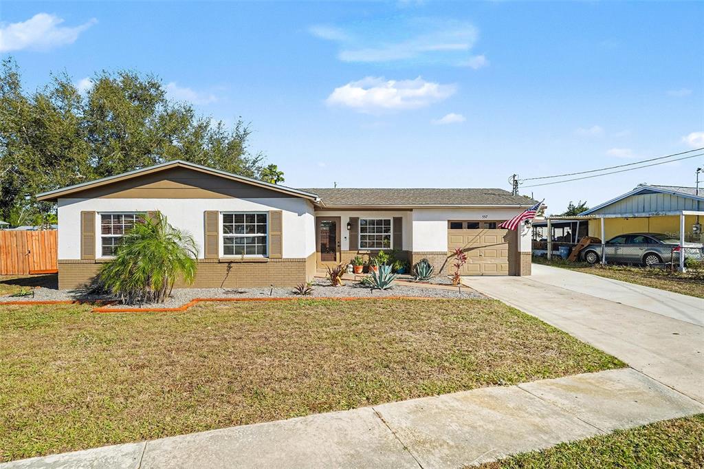 557 Flame Tree Drive Apollo Beach, FL 33572 - Photo 2 of 31 a front view of a house with a yard and porch