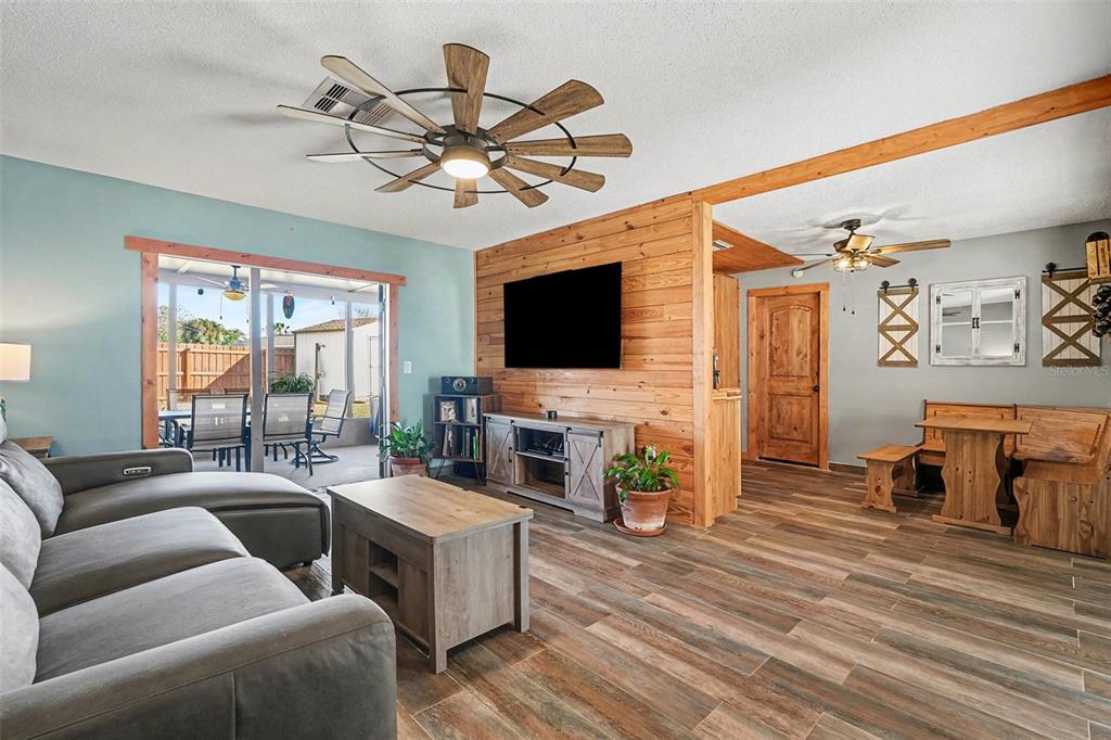 557 Flame Tree Drive Apollo Beach, FL 33572 - Photo 7 of 31 a living room with furniture and a flat screen tv