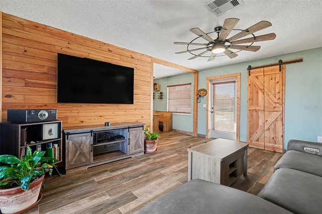 a living room with fireplace furniture and a flat screen tv