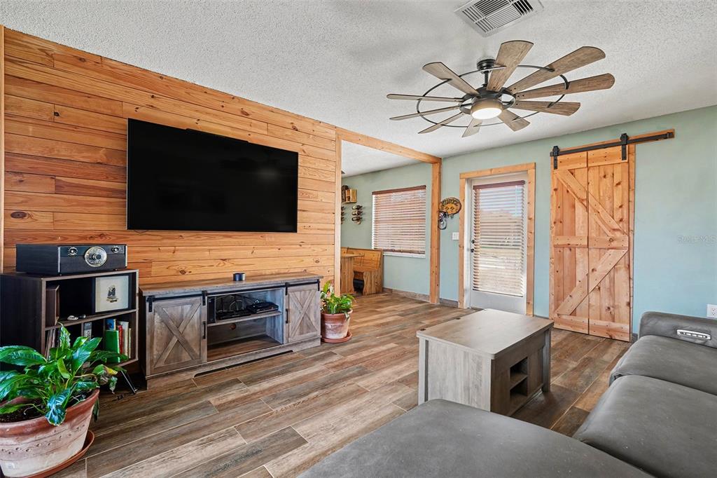 557 Flame Tree Drive Apollo Beach, FL 33572 - Photo 8 of 31 a living room with fireplace furniture and a flat screen tv