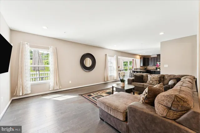 a living room with couches and a flat screen tv