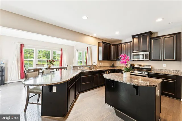 a kitchen with granite countertop a sink stove and cabinets
