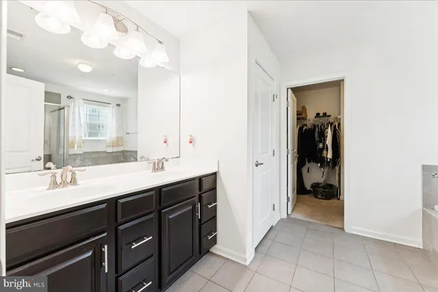 a bathroom with a double vanity sink and mirror