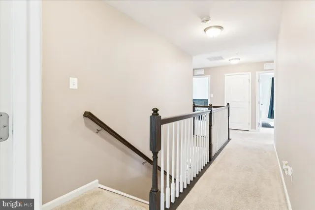 a view of a hallway with stairs