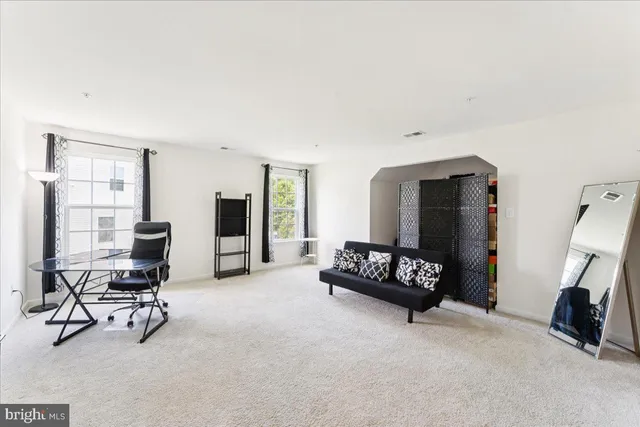 a living room with furniture gym equipment and a window