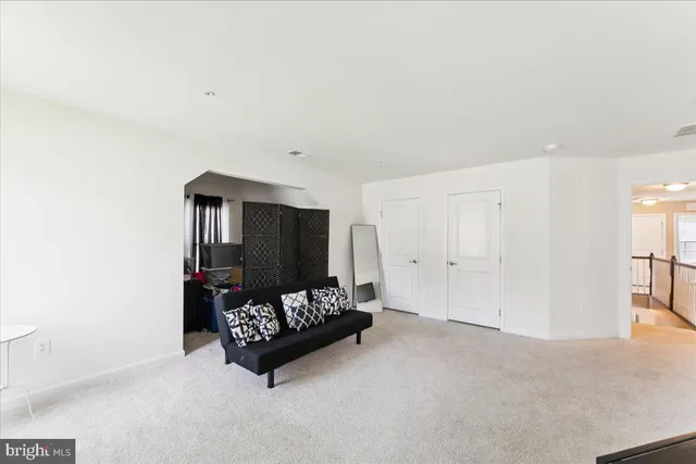 a living room with furniture and a ceiling fan