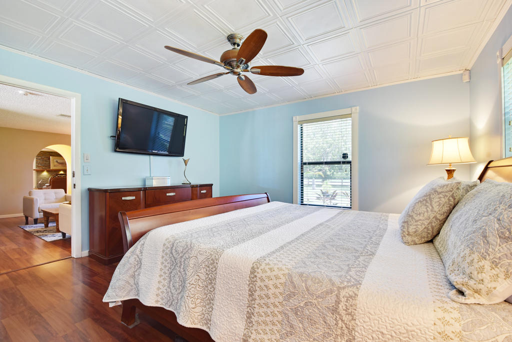 15429 Jupiter Farms Road Jupiter, FL 33478 - Photo 33 of 59 a bedroom with a bed and a flat screen tv