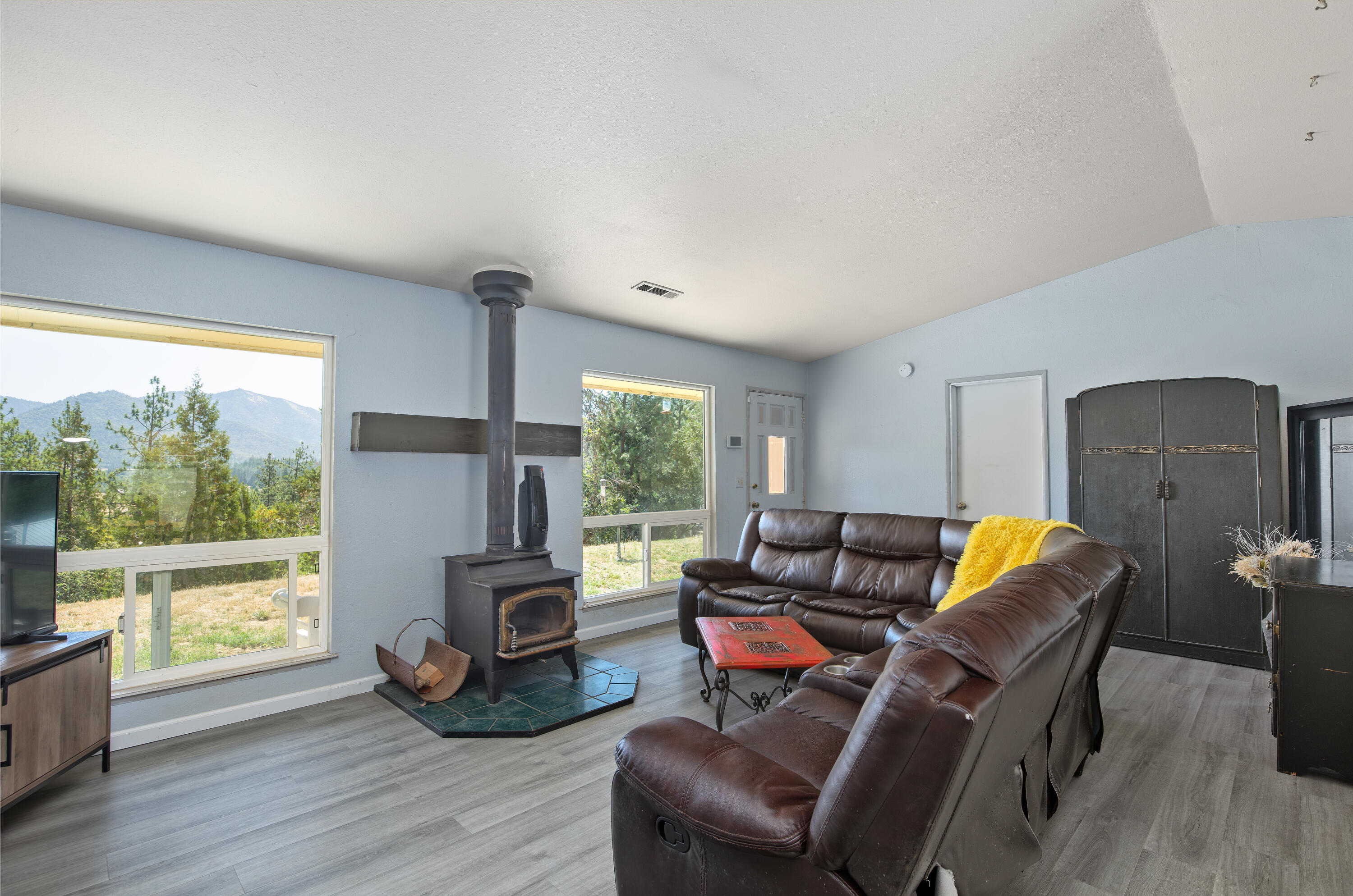 12748 Water Gap Road Williams, OR 97544 - Photo 9 of 35 a living room with furniture and a flat screen tv