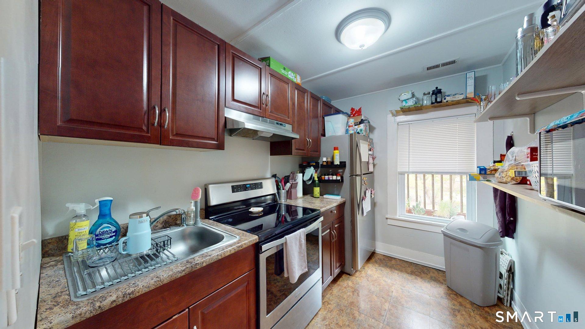 138 Main Street Somers, CT 06071 - Photo 23 of 38 a kitchen with stainless steel appliances granite countertop a refrigerator a sink dishwasher a stove and white countertops with cabinets