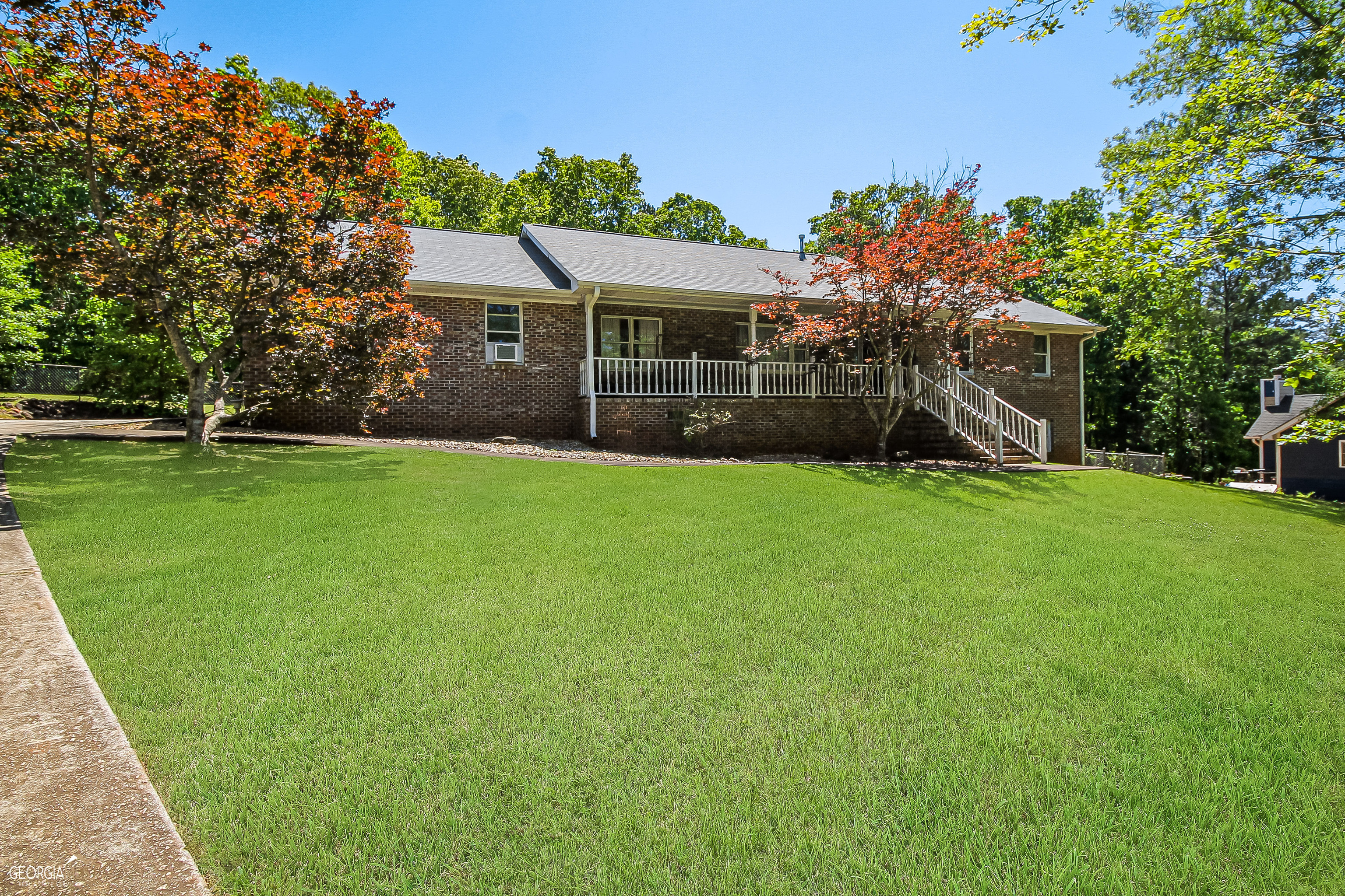 a front view of house with yard and green space