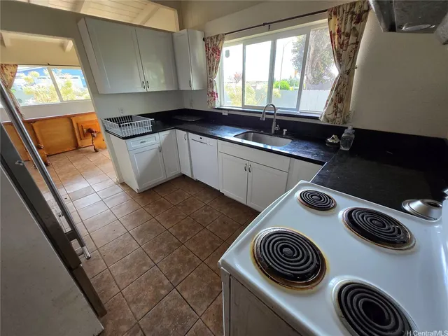 a kitchen with a sink and a stove top oven