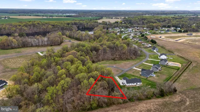 an aerial view of residential houses with outdoor space and swimming pool