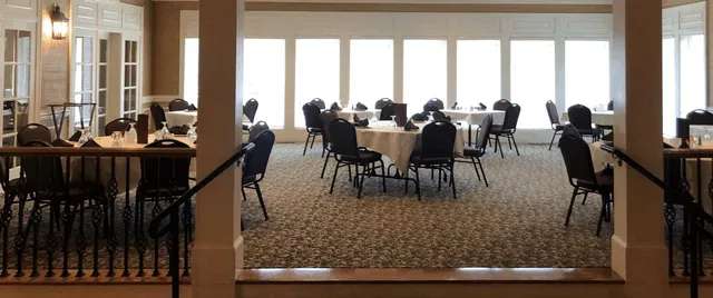 a dining room with furniture a rug and a chandelier