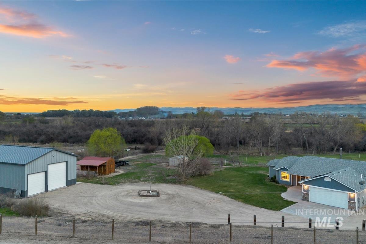 2417 Patch Ditch Road Homedale, ID 83628 - Photo 1 of 50 Yard at dusk with an outbuilding, a detached garage, a rural view, and dirt driveway