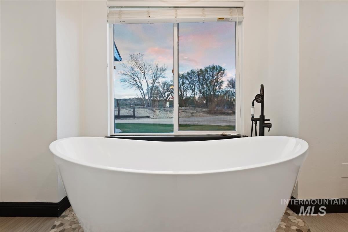 2417 Patch Ditch Road Homedale, ID 83628 - Photo 24 of 50 Bathroom featuring baseboards and a freestanding bath