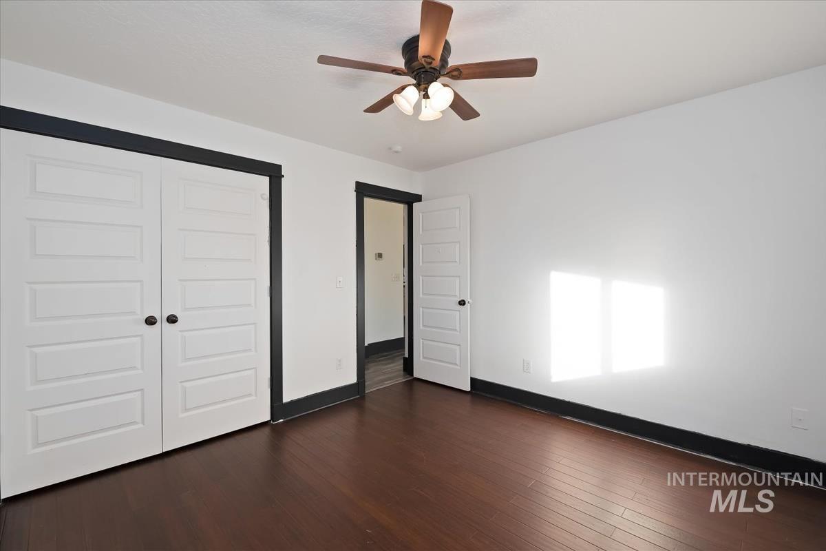 2417 Patch Ditch Road Homedale, ID 83628 - Photo 27 of 50 Unfurnished bedroom with dark wood-style flooring, a closet, and ceiling fan