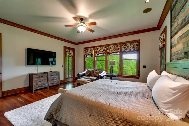 a spacious bedroom with a large bed and a flat screen tv