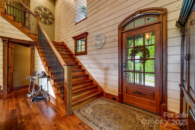 a view of an entryway with wooden floor and door