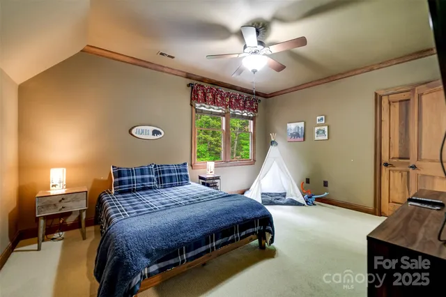 a bedroom with a bed and a chandelier