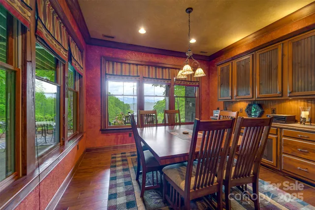 a dining room with furniture a chandelier and wooden floor