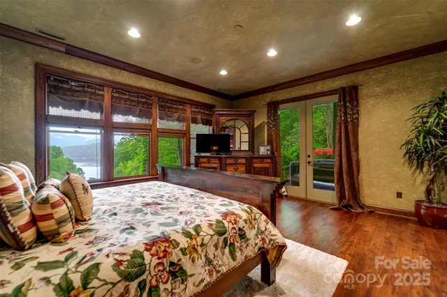 a spacious bedroom with a large bed and a large window