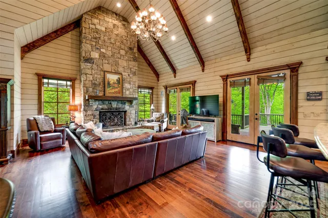 a living room with furniture a fireplace and a large window