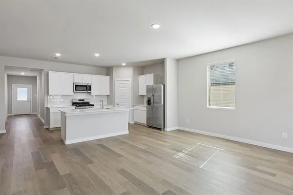 a view of a big room with wooden floor closet and windows