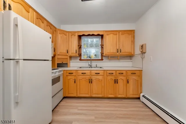 a view of a livingroom with wooden floor and staircase