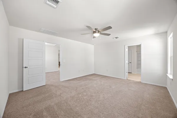 a view of an empty room with a bathroom