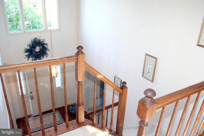 2456 Bear Den Road Frederick, MD 21701 - Photo 4 of 8 a view of staircase with wooden floor and a window