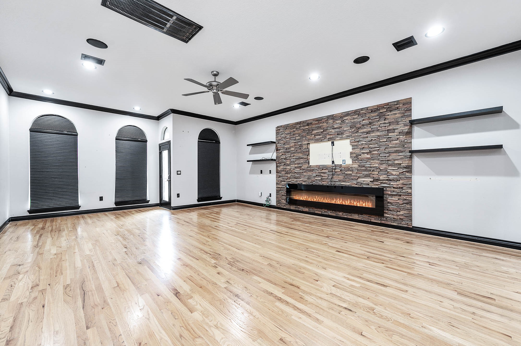 2503 Dallas Street Houston, TX 77003 - Photo 11 of 30 a view of an empty room with a fireplace and wooden floor
