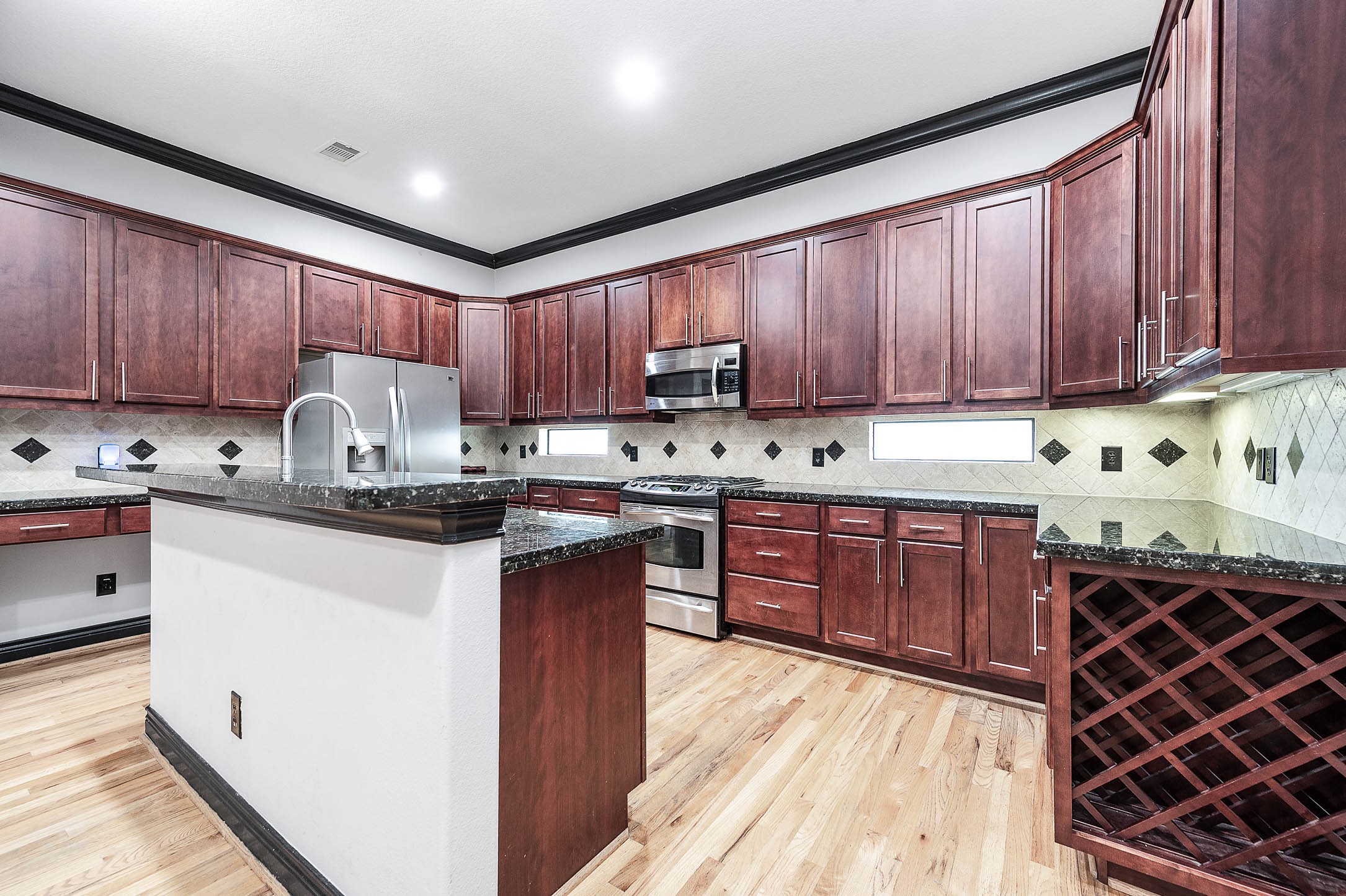 2503 Dallas Street Houston, TX 77003 - Photo 16 of 30 a kitchen with stainless steel appliances granite countertop a stove sink and cabinets