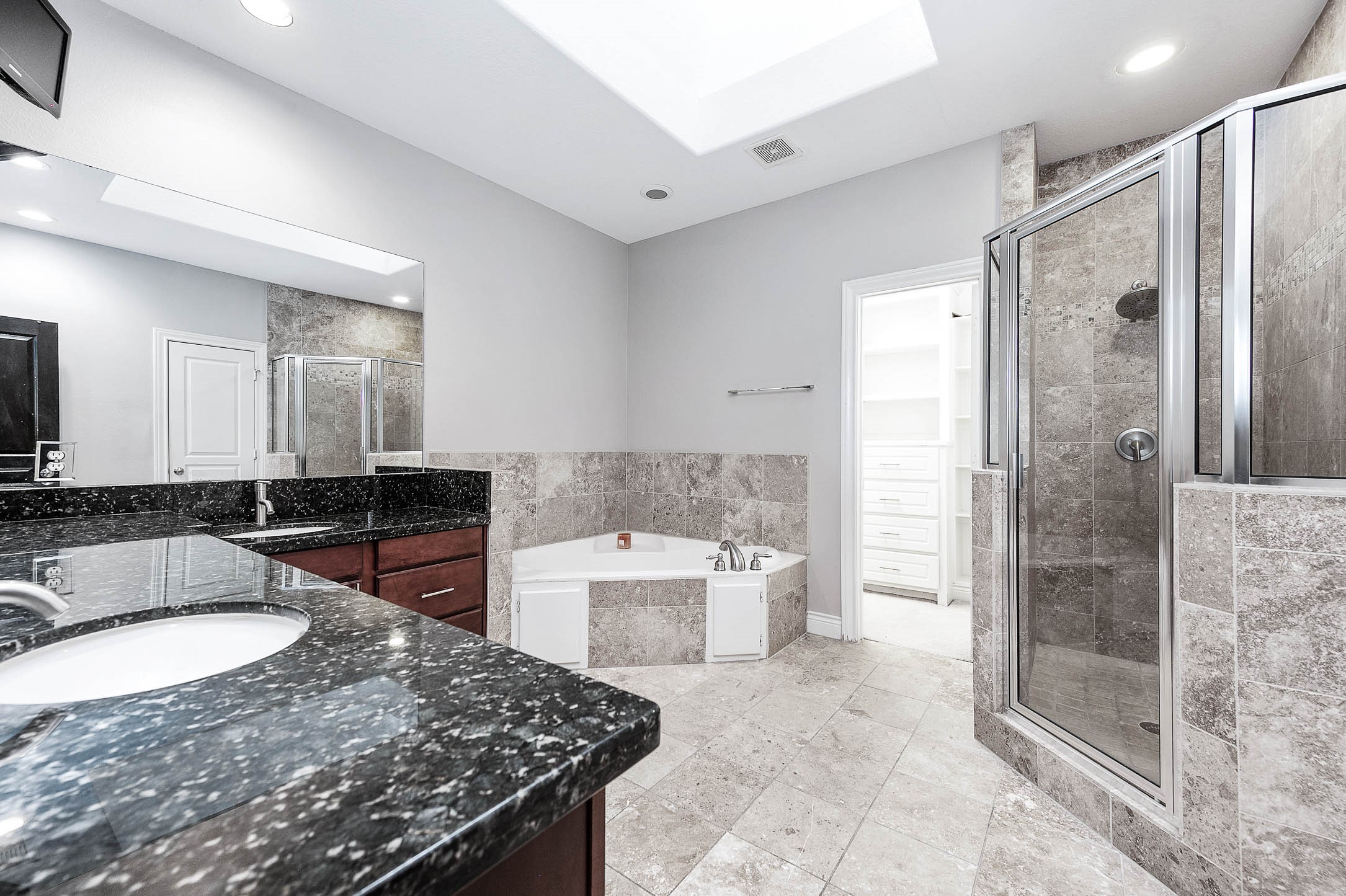2503 Dallas Street Houston, TX 77003 - Photo 23 of 30 a bathroom with a granite countertop sink a mirror and a bathtub