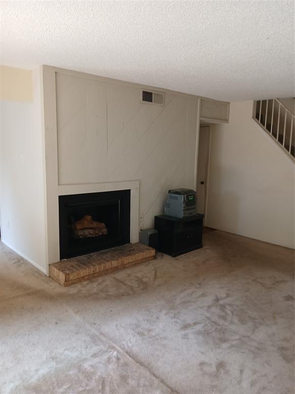 7456 East Northwest Highway, Unit H 125 Dallas, TX 75231 - Photo 6 of 10 a living room with a fireplace