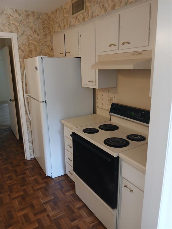 7456 East Northwest Highway, Unit H 125 Dallas, TX 75231 - Photo 8 of 10 a stove top oven sitting inside of a kitchen