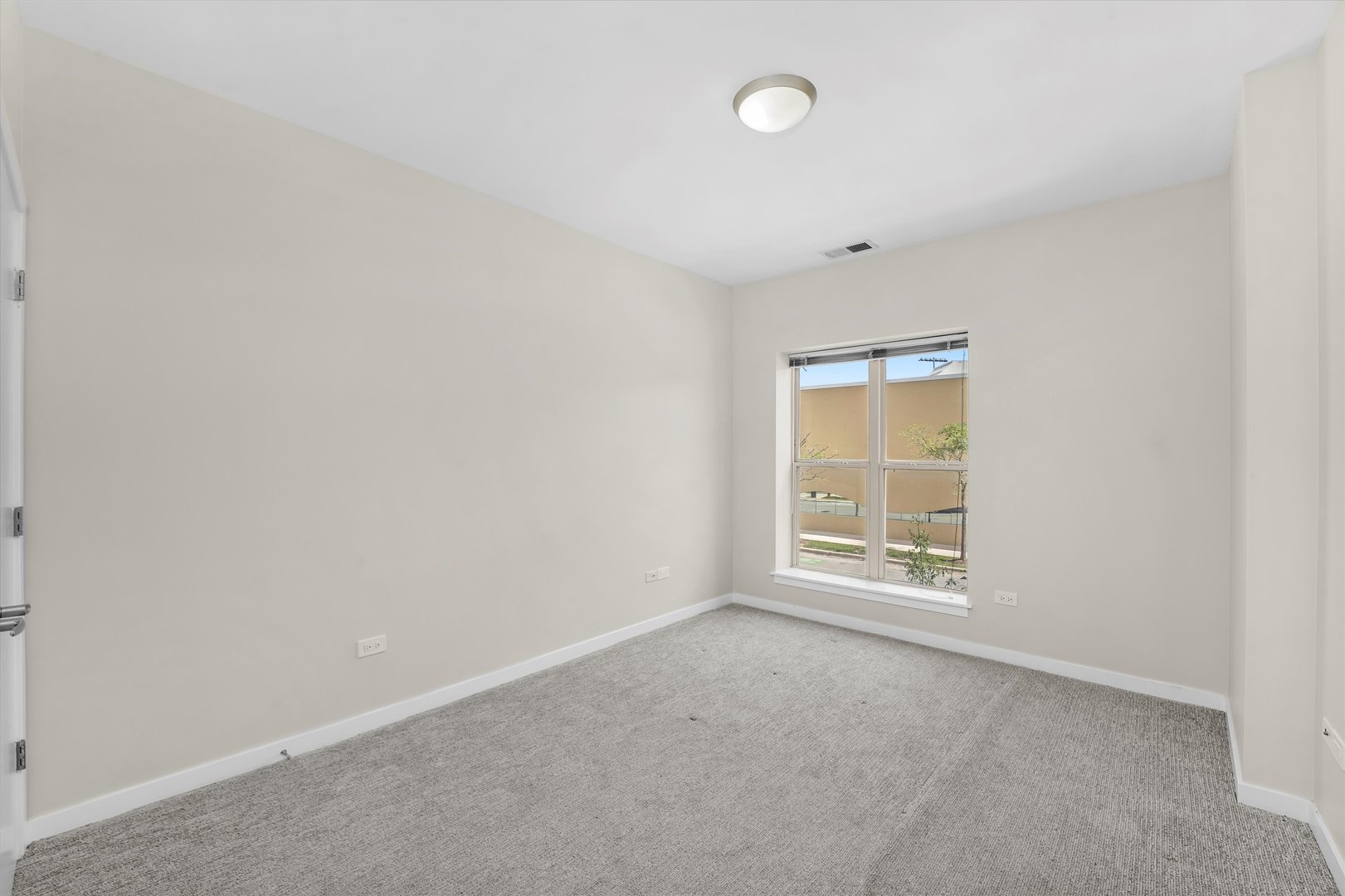 1075 West Roosevelt Road, Unit 206 Chicago, IL 60608 - Photo 11 of 17 an empty room with a window