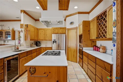 a kitchen with stainless steel appliances a sink stove and refrigerator