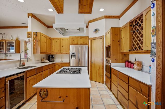 a kitchen with stainless steel appliances a sink stove and refrigerator