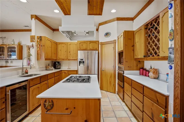 a kitchen with stainless steel appliances a sink stove and refrigerator